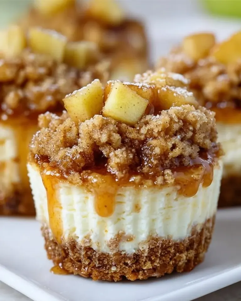 Delicious Apple Crisp Mini Cheesecakes topped with crunchy apple topping.
