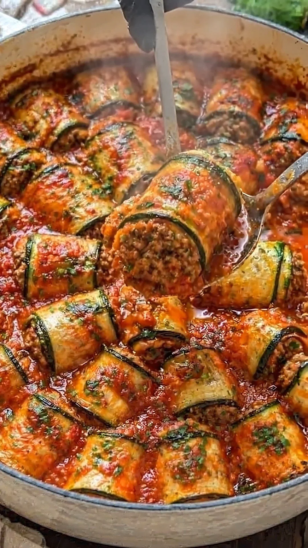 Low-carb zucchini lasagna roll-ups garnished with fresh herbs