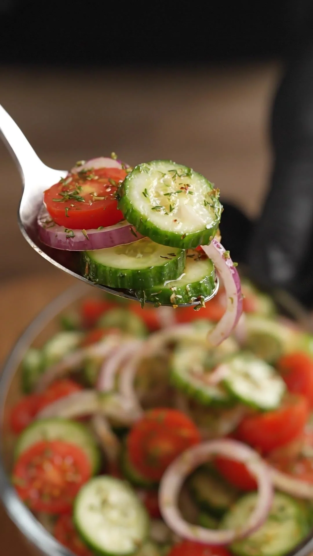 Delicious marinated cucumbers, onions, and tomatoes in a serving bowl