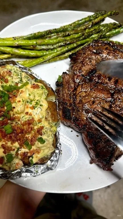 Smoked ribeye served with cheddar and broccoli loaded baked potato