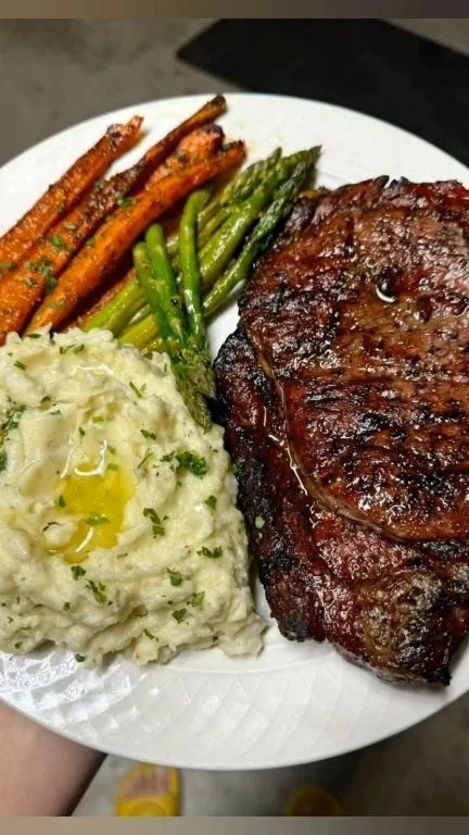 Smoked ribeye steak served with roasted vegetables and creamy Yukon Gold mashed potatoes.