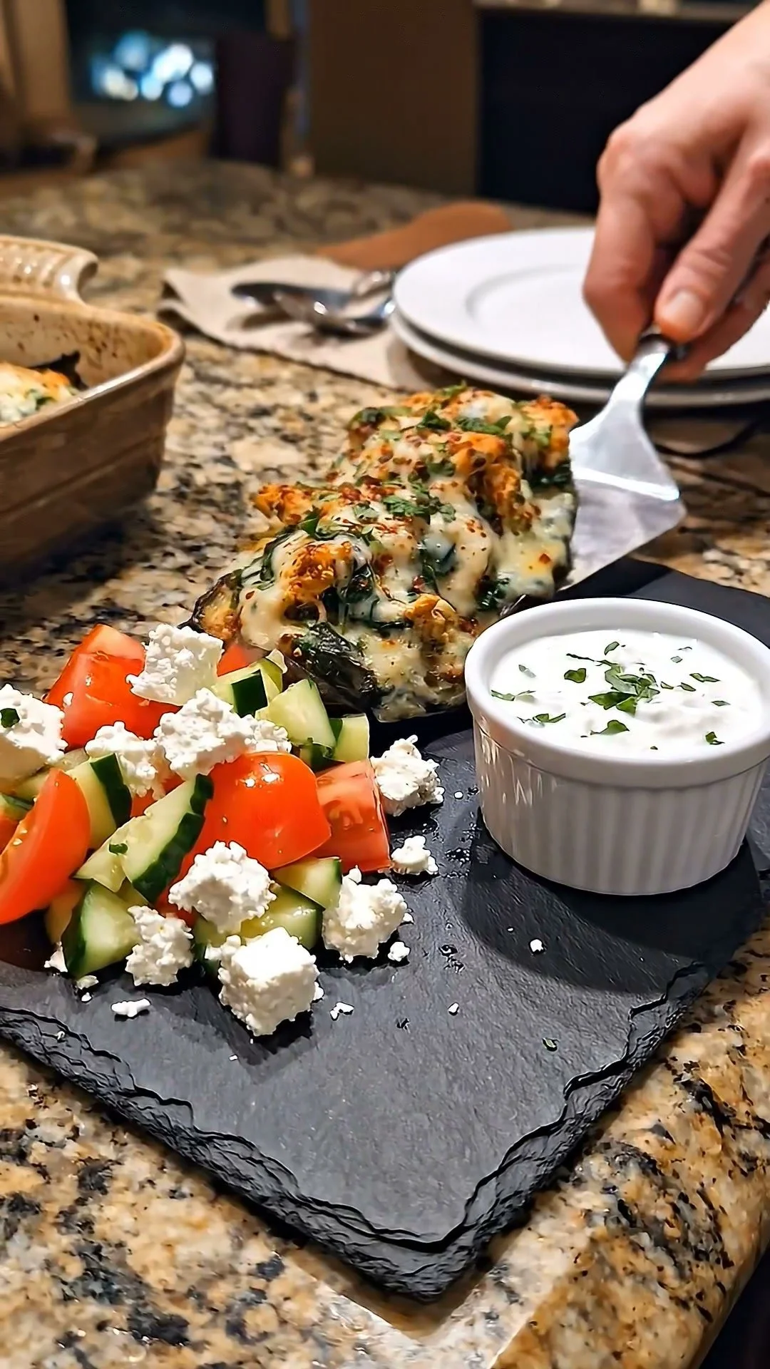 Spinach chicken stuffed eggplants served on a plate with garnish